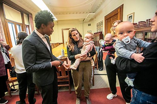 MIKAELA MACKENZIE / FREE PRESS
Health minister Uzoma Asagwara (left) chats with Hannah James (with nine-month-old Margaret Chenier), Brianna Boyse (with five-month-old Julien Croy), and Eleni Kirkikis (with eight-month-old Rudy Smith-Kirkikis) after announcing a new Manitoba parenting website on Wednesday, Oct. 22, 2025. 
For Chris Kitching story.
Free Press 2025