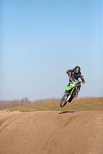 Scott Harland of Brandon gets some a little air over one of the hills of a dirt bike track along the Trans-Canada Highway west of Grand Valley on a warm and sunny Thursday afternoon. The sixty-five-year-old, who was out on the course with fellow Brandon dirt bike enthusiast Dave Mahoney, has been racing dirt bikes since he was a teenager, and still engages in race events. (Matt Goerzen/The Brandon Sun)