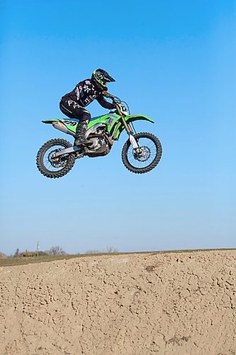 Scott Harland of Brandon gets some air over one of the hills of a dirt bike track along the Trans-Canada Highway west of Grand Valley on a warm and sunny Thursday afternoon. The sixty-five-year-old, who was out with fellow Brandon dirt bike enthusiast Dave Mahoney, has been racing dirt bikes since he was a teenager, and still engages in race events. (Matt Goerzen/The Brandon Sun)