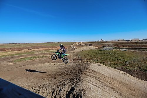 Sixty-five-year-old Scott Harland of Brandon takes a jump over one of the hills of a dirt bike track along the Trans-Canada Highway west of Grand Valley on a warm and sunny Thursday afternoon. Harland, who was out on the course with fellow Brandon dirt bike enthusiast Dave Mahoney, has been racing dirt bikes since he was a teenager and still engages in race events now. (Matt Goerzen/The Brandon Sun)