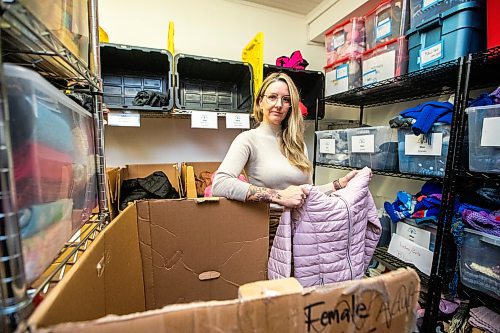 MIKAELA MACKENZIE / FREE PRESS

Hillary Gair, senior manager for engagement initiatives at United Way Winnipeg, at Koats for Kids on Monday, Oct. 27, 2025. Their stock of kids jackets is running low due to a lack of donations (especially in sizes 8-12, like the one she is holding).

For intern story.
Free Press 2025
