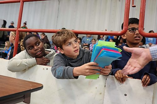 Elementary school students bid on cattle during a pretend cattle auction. (Tim Smith/The Brandon Sun)