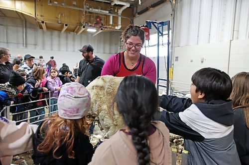 29102025
Bethan Lewis with Cross Creek Farm in Alexander shows grade four students from Earl Oxford School freshly shorn sheep wool during day one of Manitoba AG EX, the all-breed cattle show runs until Saturday.
(Tim Smith/The Brandon Sun)