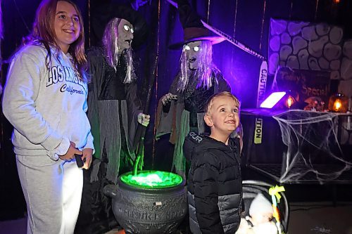 Cousins Adelyn Commer and Reece Slack explore the haunted house at Alternative Choice Garden Centre in Brandon on Thursday. The business has teamed up with The Green Spot and Livingstone Outdoor for the Halloween Hop, offering Halloween-related activities to visitors and collecting donations for various local charities. (Tim Smith/The Brandon Sun)