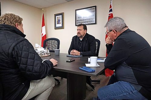 Brandon East NDP MLA and Minister of Municipal and Northern Relations, Glen Simard sits down around the table with Brandon Sun reporter Alex Lambert, left, and NDP staffer Ray Berthelette at right in his constituency office on 10th Street on Friday morning. (Matt Goerzen/The Brandon Sun)
