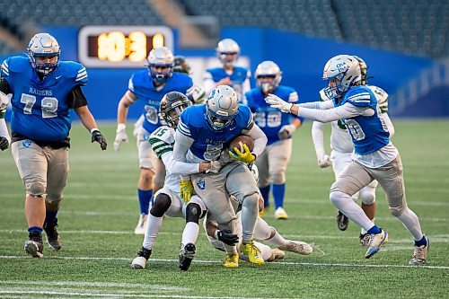 BROOK JONES/FREE PRESS
The Oak Park Raiders host the Vincent Massey Trojans in Winnipeg High School Football League AAAA Tier 1 semifinal action at Princess Auto Stadium in Winnipeg, Man., Friday, Oct. 31, 2025. The Raiders eared a 46-7 victory. Pictured: Oak Park Raiders running back Graycen Ross (No. 5) runs with the football while Vincent Massey Trojans defensive back Trevor Johnstone (No. 15) and Trojans teammate defensive lineman Braxten Cockell (No. 5) try to tackle him during third quarter action.