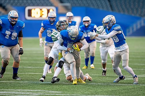 BROOK JONES/FREE PRESS
The Oak Park Raiders host the Vincent Massey Trojans in Winnipeg High School Football League AAAA Tier 1 semifinal action at Princess Auto Stadium in Winnipeg, Man., Friday, Oct. 31, 2025. The Raiders eared a 46-7 victory. Pictured: Oak Park Raiders running back Graycen Ross (No. 5) runs with the football while Vincent Massey Trojans defensive back Trevor Johnstone (No. 15) and Trojans teammate defensive lineman Braxten Cockell (No. 5) try to tackle him during third quarter action.