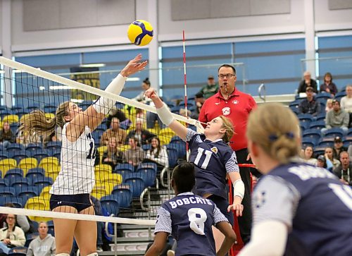 Mount Royal's Sydney Scatcherd, left, and Carly Thomson vie for the ball during the third set. (Thomas Friesen/The Brandon Sun)