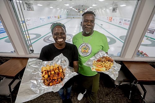 JOHN WOODS / FREE PRESS
Donna Taylor, Social Marketing Manager, and Vincent Dennis, owner of Tropical Thunder House of Jerk - Jamaican/Italian restaurant, prepares a Rocka Bessa burger and T.T. Wings in his restaurant in the West St. Paul Curling Club Tuesday, November 4, 2025. 

Reporter: dave