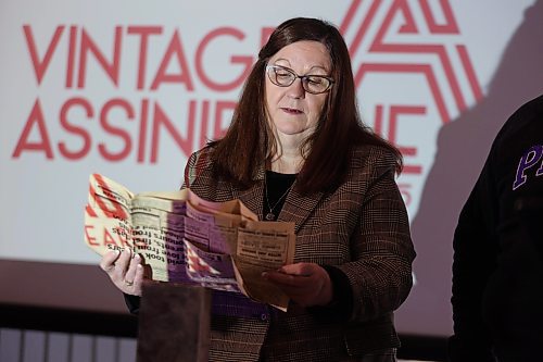 Assiniboine College library clerk Kimberley Lynn examines newspaper clippings from 1966 detailing the renaming of Manitoba Vocational School to Assiniboine Community College. (Alex Lambert/The Brandon Sun)