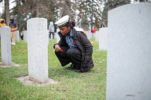 06112025
Akunna Emedosi, a grade five student at St. Augustine School and a member of the Navy League Cadet Corp #4 Stan Hawitt, places a poppy at a headstone during the annual No Stone Left Alone ceremony at the Brandon Municipal Cemetery on Thursday.
(Tim Smith/The Brandon Sun)