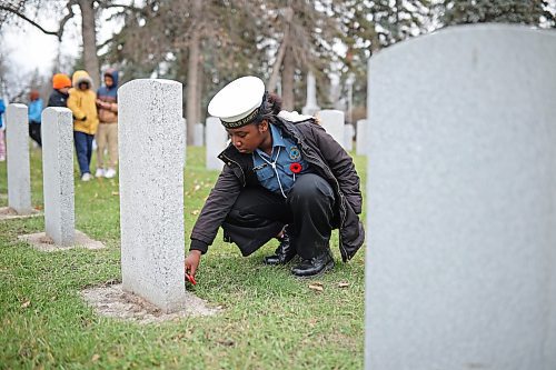 06112025
Akunna Emedosi, a grade five student at St. Augustine School and a member of the Navy League Cadet Corp #4 Stan Hawitt, places a poppy at a headstone during the annual No Stone Left Alone ceremony at the Brandon Municipal Cemetery on Thursday.
(Tim Smith/The Brandon Sun)