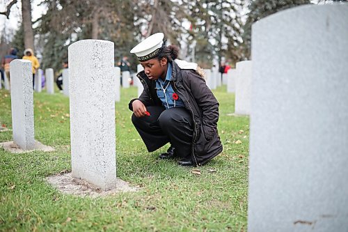06112025
Akunna Emedosi, a grade five student at St. Augustine School and a member of the Navy League Cadet Corp #4 Stan Hawitt, places a poppy at a headstone during the annual No Stone Left Alone ceremony at the Brandon Municipal Cemetery on Thursday. 
(Tim Smith/The Brandon Sun)