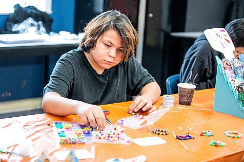 MIKAELA MACKENZIE / FREE PRESS
Marty Harper, 12, makes bracelets at the craft sale table at the Rossbrook House open house on Thursday, Nov. 6, 2025.
Standup.
Free Press 2025