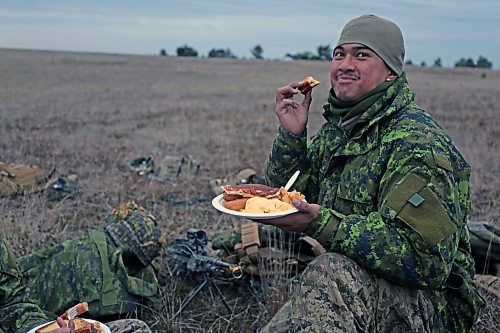 Gunner Kerryvon Basilio enjoys a fresh pancake, sausage, french toast, eggs and hashbrown breakfast served near a gun line on Thursday morning. It came during the middle of a roughly week-long exercise where soldiers lived out of tents, and on rations. (Connor McDowell/The Brandon Sun)