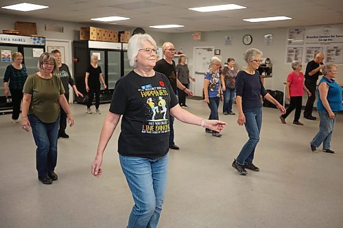 10112025
Barb Berry sports an upbeat line dancing shirt while taking part in the weekly beginner line dancing class with other dance enthusiasts at the Seniors for Seniors Co-Op on Monday morning.
(Tim Smith/The Brandon Sun)