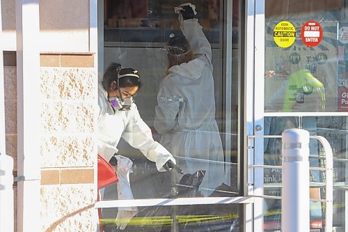 Mike Deal / Free Press
The Shoppers at 795 Keewatin Street is closed after an incident. Cleaners can be seen in hazmat suits wiping down the entrance area and disposing of cloths in garbage bags. A security guard posted outside the store had nothing to say. Police tape draped across the outside of the store. 
251112 - Wednesday, November 12, 2025. 