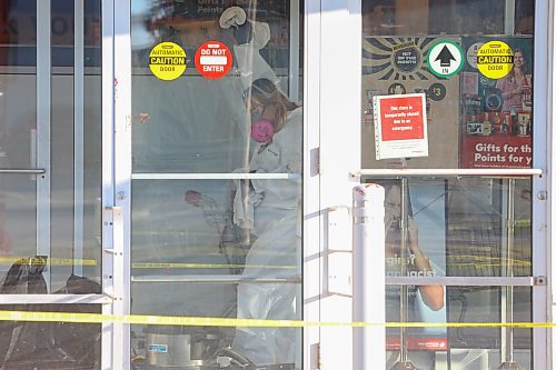 Mike Deal / Free Press
The Shoppers at 795 Keewatin Street is closed after an incident. Cleaners can be seen in hazmat suits wiping down the entrance area and disposing of cloths in garbage bags. A security guard posted outside the store had nothing to say. Police tape draped across the outside of the store. 
251112 - Wednesday, November 12, 2025. 