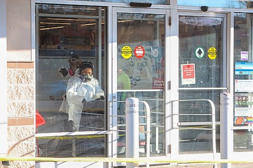 Mike Deal / Free Press
The Shoppers at 795 Keewatin Street is closed after an incident. Cleaners can be seen in hazmat suits wiping down the entrance area and disposing of cloths in garbage bags. A security guard posted outside the store had nothing to say. Police tape draped across the outside of the store. 
251112 - Wednesday, November 12, 2025. 