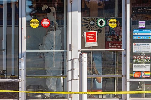 MIKE DEAL / FREE PRESS
The Shoppers at 795 Keewatin Street is closed after an incident. Cleaners can be seen in hazmat suits wiping down the entrance area and disposing of cloths in garbage bags. A security guard posted outside the store had nothing to say. Police tape draped across the outside of the store.
251112 - Wednesday, November 12, 2025.