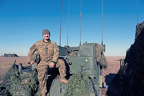 Michael St. Louis McIntosh pops out of the command post during a pause between artillery firing missions at CFB Shilo. McIntosh is one of a team that calculated how to fire shells roughly 8 kilometres down range. (Connor McDowell/The Brandon Sun)
