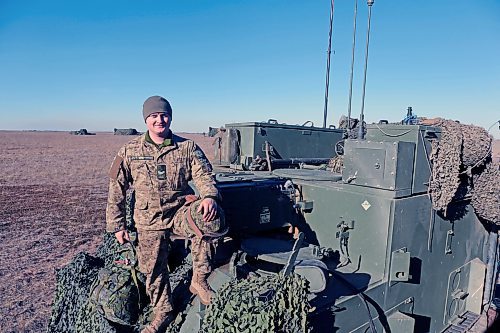 Michael St. Louis McIntosh pops out of the command post during a pause between artillery firing missions at CFB Shilo. McIntosh is one of a team that calculated how to fire shells roughly 8 kilometres down range. (Connor McDowell/The Brandon Sun)