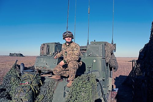 Michael St. Louis McIntosh pops out of the command post during a pause between artillery firing missions at CFB Shilo. McIntosh is one of a team that calculated how to fire shells roughly 8 kilometres down range. (Connor McDowell/The Brandon Sun)