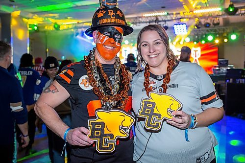 BROOK JONES/FREE PRESS
Self-proclaimed superfan Kyle Dunn, 43, (left) and his partner Heather Smith, 40, who are Surrey, B.C.., are pictured having fun inside the Team Party Room - Spirit of Edmonton at the Grey Cup Festival at the RBC Convention Centre in Winnipeg, Man., Thursday, Nov. 13, 2025. Dunn has attended 22 Grey Cups since he was 16 years old and 22 in a row.