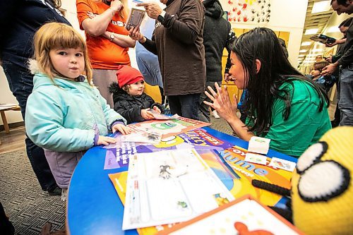 MIKAELA MACKENZIE / FREE PRESS

Trisha Valencia, TOYBOX project development research assistant, gives activity packages out to Fern McDonough (four, left) and Dawn McDonough (two) at the UWSA daycare on Wednesday, Nov. 19, 2025. 

Standup.
Free Press 2025