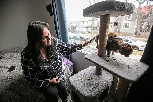 MIKAELA MACKENZIE / FREE PRESS

Rachelle St. Cyr, who has used the food bank before and said she&#039;s scraped together change and gone without food herself to provide for her three cats, with cat Mittens on Wednesday, Nov. 19, 2025. he WHS is holding a holiday pet food bank drive for the first time after visits to their food bank jumped over 250 per cent in less than a year.

For Malak story.
Free Press 2025