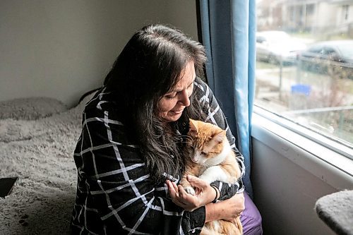 MIKAELA MACKENZIE / FREE PRESS

Rachelle St. Cyr, who has used the food bank before and said she&#039;s scraped together change and gone without food herself to provide for her three cats, with cat Max on Wednesday, Nov. 19, 2025. he WHS is holding a holiday pet food bank drive for the first time after visits to their food bank jumped over 250 per cent in less than a year.

For Malak story.
Free Press 2025