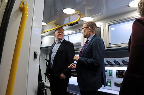 MoveMobility founder Richard Jones (left) chats with Winnipeg West MP Dr. Doug Eyolfson inside one of the company's custom ambulance vans on Friday following a $1.1 million federal investment. (Tyler Searle / Free Press)