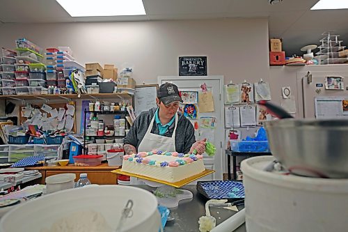 Courtney Jacobson, owner of Courtney's Cake Creations, decorates a cake in late November. (Connor McDowell/The Brandon Sun)