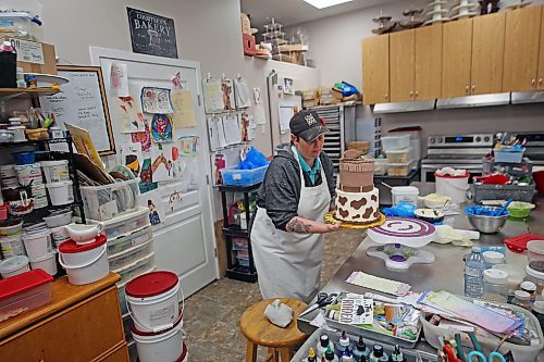 Courtney Jacobson, owner of Courtney's Cake Creations, decorates a cake in late November. (Connor McDowell/The Brandon Sun)
