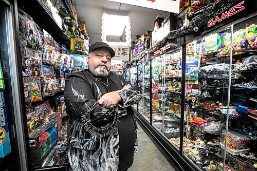MIKAELA MACKENZIE / FREE PRESS

Michael Paille, owner of Cobra Collectibles and executive director at Sargent Business Community, in his store on Friday, Nov. 28, 2025. He&#x2019;s had to lock up most of his merchandise in glass cases to fight crime.

For Malak story.
Free Press 2025