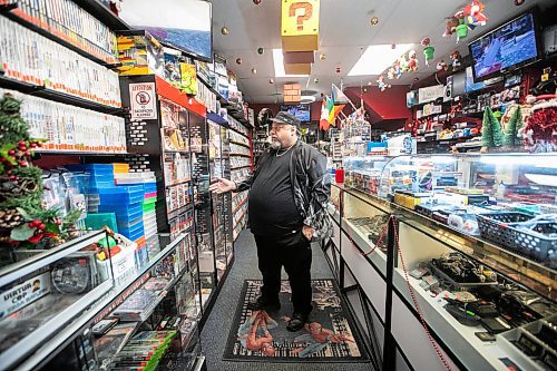 MIKAELA MACKENZIE / FREE PRESS

Michael Paille, owner of Cobra Collectibles and executive director at Sargent Business Community, in his store on Friday, Nov. 28, 2025. He&#x2019;s had to lock up most of his merchandise in glass cases to fight crime.

For Malak story.
Free Press 2025