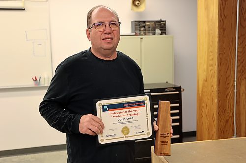 Assiniboine College electrical instructor Garry Jones holds the plaque and certificate presented to him as Apprenticeship Manitoba’s Instructor of the Year at the college's North Hill campus on Friday morning. (Abiola Odutola/The Brandon Sun)