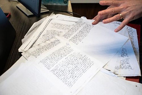 MIKAELA MACKENZIE / FREE PRESS
Roisin Cossar, University of Manitoba history department head, flips through court records from late madieval Italy on Wednesday, Dec. 3, 2025. U of M faculty are adapting to AI use by students, including making teaching more interactive and hands-on in order to encourage students to take an active role in the process.
For Melissa story.
Free Press 2025