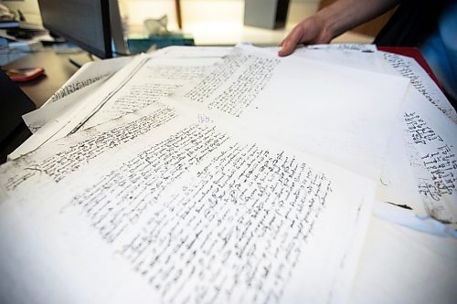MIKAELA MACKENZIE / FREE PRESS
Roisin Cossar, University of Manitoba history department head, flips through court records from late madieval Italy on Wednesday, Dec. 3, 2025. U of M faculty are adapting to AI use by students, including making teaching more interactive and hands-on in order to encourage students to take an active role in the process.
For Melissa story.
Free Press 2025