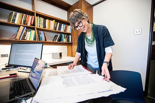 MIKAELA MACKENZIE / FREE PRESS

Roisin Cossar, University of Manitoba history department head, flips through court records from late madieval Italy on Wednesday, Dec. 3, 2025. U of M faculty are adapting to AI use by students, including making teaching more interactive and hands-on in order to encourage students to take an active role in the process.

For Melissa story.
Free Press 2025