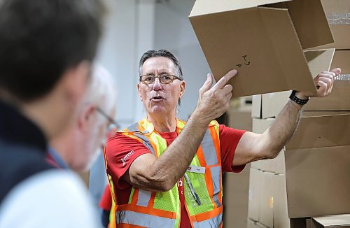 RUTH BONNEVILLE / WINNIPEG FREE PRESS
Local - Christmas Cheerboard Story
Photo of longtime volunteer, Rick Gill, warehouse operations manager, setting up sample hampers to show a group of volunteers coming in to pack hampers on the line how to properly pack the food into the boxes.
Feature at the warehouse speaking to volunteers on the sense of community that they feel.
CHEER BOARD: Every year the Cheer Board sets up for the massive undertaking of receiving, building and sending out over 18,000 hampers to families in need. Before the phone lines even open, volunteers have already been busy for weeks building a functional warehouse space, receiving food, setting up different work areas.
See TAYLOR'S Story.
Nov 30th,, 2023