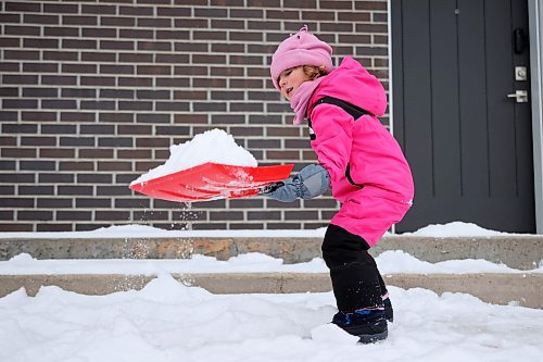 08122025
Three-year-old Aaliyah works hard to clear snow outside her family&#x2019;s home in Brandon on Monday afternoon after the wheat city received fresh snow earlier in the day. According to Environment Canada, Brandon is under a winter storm watch for Tuesday. 
(Tim Smith/The Brandon Sun)
***No last name given