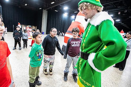 MIKAELA MACKENZIE / FREE PRESS

Grade one and two Elwick Community School students Clifford Manningway (left), Xavier Bearbull-Worme, and Christopher Devisser greet Buddy the elf at the Winter Wonderland party for children from under-resourced areas, put on by Variety Manitoba, at the RBC Convention Centre on Tuesday, Dec. 9, 2025.

Standup.
Free Press 2025
