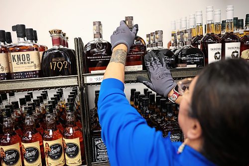 10122025
Roberta Rosen with the Manitoba Liquor Mart on 10th Street and Victoria Avenue helps stock American alcohol onto shelves at the retailer on Wednesday morning. The American alcohol in stock is available to purchase while supplies last or until December 24th, and is only available in Brandon at the Victoria Avenue Manitoba Liquor Mart location. Manitoba Liquor and Lotteries Corporation stopped selling American alcohol in February in response to tariffs imposed by U.S. President Donald Trump. Proceeds from the sale of US alcohol over the next two weeks will go to local and provincial charities and food banks. 
(Tim Smith/The Brandon Sun)