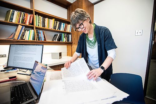 MIKAELA MACKENZIE / FREE PRESS

Roisin Cossar, University of Manitoba history department head, flips through court records from late madieval Italy on Wednesday, Dec. 3, 2025. U of M faculty are adapting to AI use by students, including making teaching more interactive and hands-on in order to encourage students to take an active role in the process.

For Melissa story.
Free Press 2025