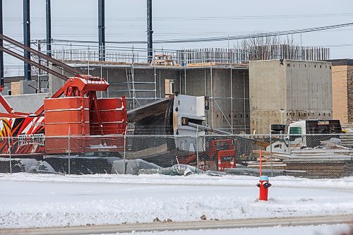 MIKE DEAL / FREE PRESS
A large dump truck lies on its side in the construction yard of the old Capri Motel Thursday morning.
A person was seen being taken away in an ambulance. 
251211 - Thursday, December 11, 2025.