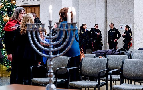 JOHN WOODS / WINNIPEG FREE PRESS
Police were on hand when Winnipeg mayor Scott Gillingham and Rabbi Avrohom Altein light the menorah on the second night of Hanukkah at City Hall Monday, December 15, 2025. 

reporter: chris and scott