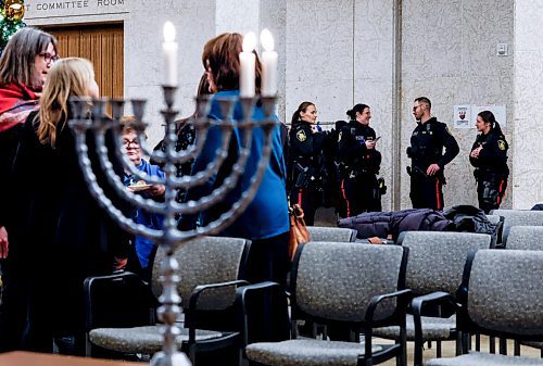 JOHN WOODS / WINNIPEG FREE PRESS
Police were on hand when Winnipeg mayor Scott Gillingham and Rabbi Avrohom Altein light the menorah on the second night of Hanukkah at City Hall Monday, December 15, 2025. 

reporter: chris and scott