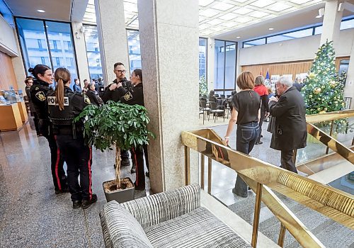 JOHN WOODS / WINNIPEG FREE PRESS
Police were on hand when Winnipeg mayor Scott Gillingham and Rabbi Avrohom Altein light the menorah on the second night of Hanukkah at City Hall Monday, December 15, 2025. 

reporter: chris and scott