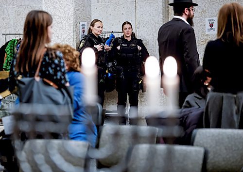 JOHN WOODS / WINNIPEG FREE PRESS
Police were on hand when Winnipeg mayor Scott Gillingham and Rabbi Avrohom Altein light the menorah on the second night of Hanukkah at City Hall Monday, December 15, 2025. 

reporter: chris and scott